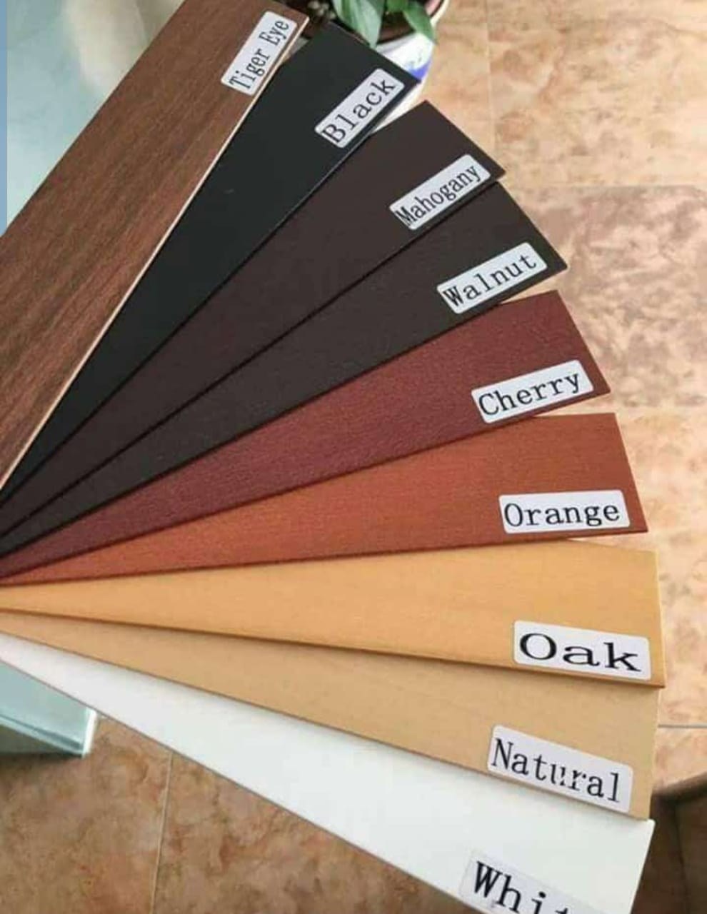 Physical finish card showing nine slat colours: Tiger Eye, Black, Mahogany, Walnut, Cherry, Orange, Oak, Natural and White